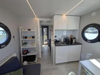 a kitchen with a sink and a counter top at Gezellige houseboat Eclipse Monnickendam nabij Amsterdam in Monnickendam