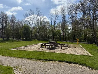 a park with two picnic tables in the grass at Vakantiehuis met strand Noord-holland op 5 min & ruime tuin VP078 in Warmenhuizen