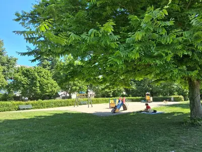 a family playing in a park under a tree at House nearby Amsterdam in Almere