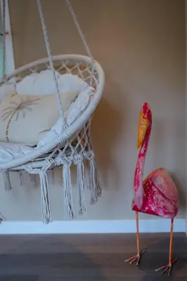 a pink flamingo standing in front of a bed at Duijnparadijs in Schoorl