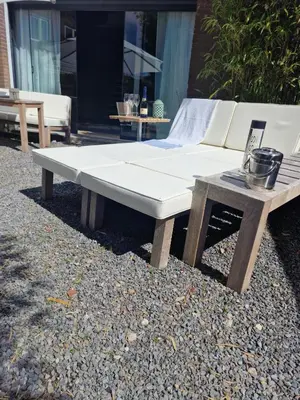 a white couch and a table on the ground at The Beach House in Schellinkhout