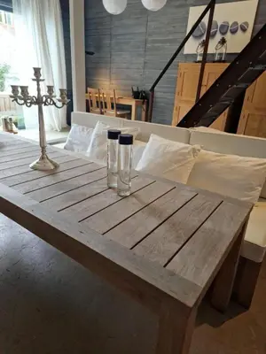 a wooden table with two glasses on top of it at The Beach House in Schellinkhout
