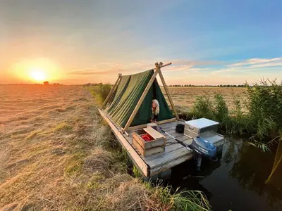 a tent on a dock in the middle of a field at Campingraft Katwoude in Katwoude