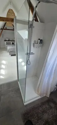 a bathroom with a glass shower in a room at Centrally located, fully furnished luxury apartment in Gouda