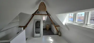 an attic room with a staircase and a stair case at Centrally located, fully furnished luxury apartment in Gouda