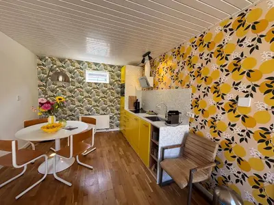 a kitchen and dining room with a table and a counter at Bungalow at the Beach in Noordwijk aan Zee