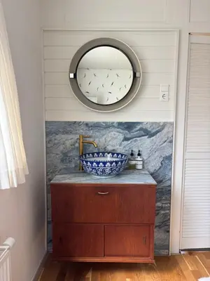 a bathroom with a sink and a mirror at Bungalow at the Beach in Noordwijk aan Zee