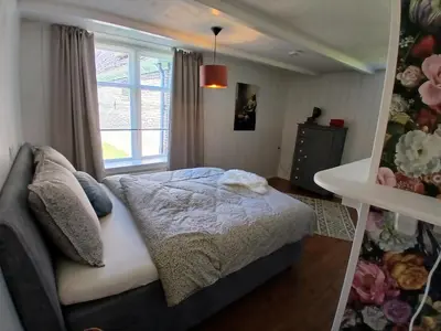 a bedroom with a bed and a window at Vakantiewoning De 