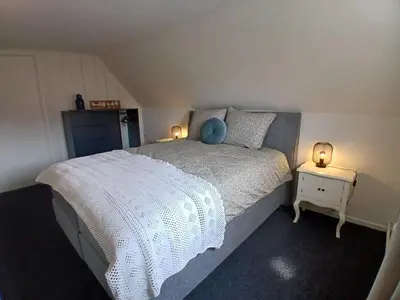 a bedroom with a bed with two lights on it at Vakantiewoning De 