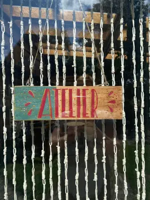 a sign with the word autism hanging from a fence at De Verborgen Pracht in Schagen
