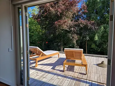 two chairs and a table on a patio at Loft with parkside view in Amsterdam