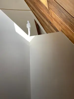 a room with a white wall with a ceiling at Loft with parkside view in Amsterdam