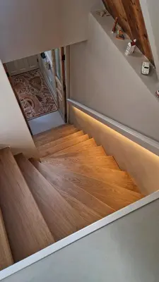 a staircase with wood flooring in a house at Loft with parkside view in Amsterdam