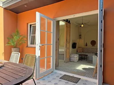 an open door to a patio with a table and chairs at Beach Hide-out Zandvoort in Zandvoort