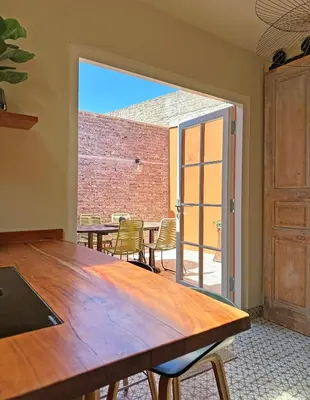 a dining room with a table and chairs and a brick wall at Beach Hide-out Zandvoort in Zandvoort