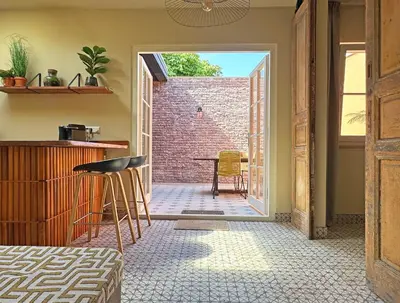 an open door to a patio with a table and chairs at Beach Hide-out Zandvoort in Zandvoort