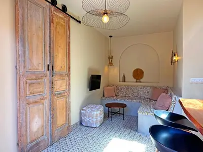 a room with a large wooden door and a couch at Beach Hide-out Zandvoort in Zandvoort
