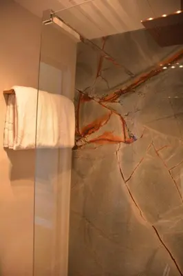 a bathroom with a towel hanging on a wall at The IF Boutique hotel in Amsterdam