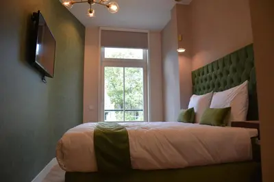a bedroom with a large bed and a window at The IF Boutique hotel in Amsterdam