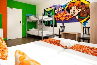 a bedroom with bunk beds and a mural of a monkey at Amsterdam Teleport Hotel - Free Parking in Amsterdam
