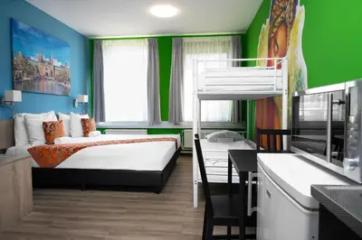 a small room with a bunk bed and a kitchen at Amsterdam Teleport Hotel - Free Parking in Amsterdam