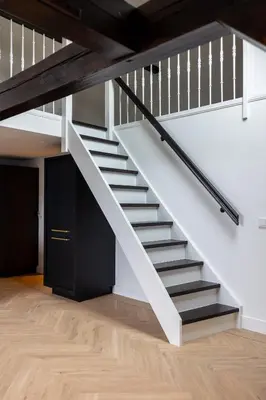 a staircase in a loft with white walls and wooden floors at De Kroonkamer in Loenen aan de Vecht