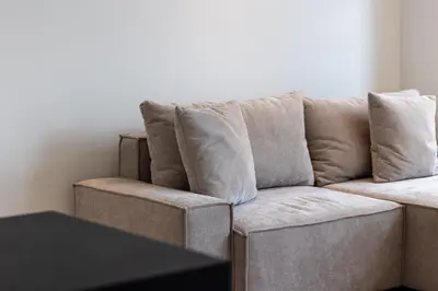 a couch with pillows on it in a living room at De Buitenplaats in Loenen aan de Vecht