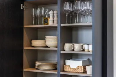 a cupboard filled with dishes and wine glasses at De Buitenplaats in Loenen aan de Vecht
