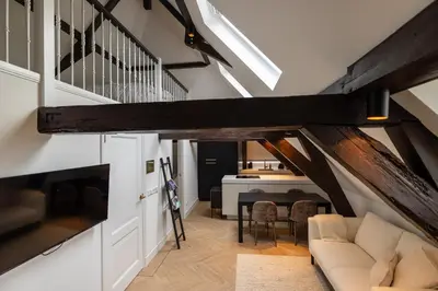 a living room with a couch and a staircase at Maison Hans in Loenen aan de Vecht