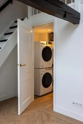 an open door to a laundry room with a washer and dryer at Maison Hans in Loenen aan de Vecht