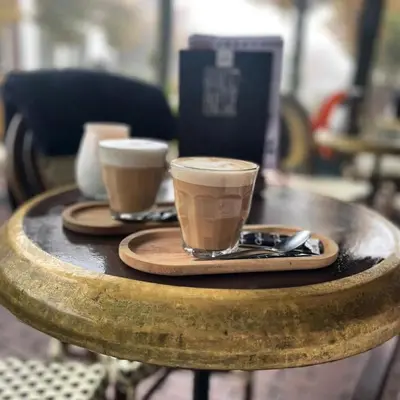 two cups of coffee sitting on a wooden table at Maison Hans in Loenen aan de Vecht