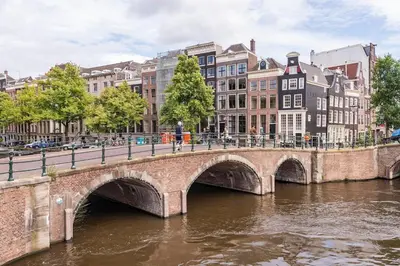 a bridge over a river in a city with buildings at Beautiful & Well-located Canal Apartment in Amsterdam