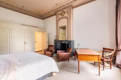 a bedroom with a bed and a table and chairs at Beautiful & Well-located Canal Apartment in Amsterdam