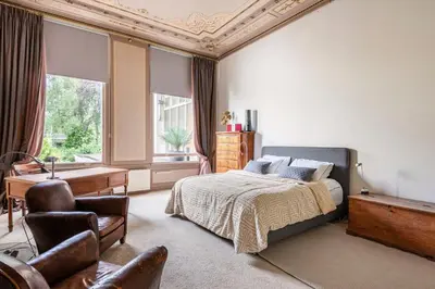a bedroom with a bed and a desk and a chair at Beautiful & Well-located Canal Apartment in Amsterdam
