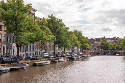a group of boats are parked on a canal at Beautiful & Well-located Canal Apartment in Amsterdam