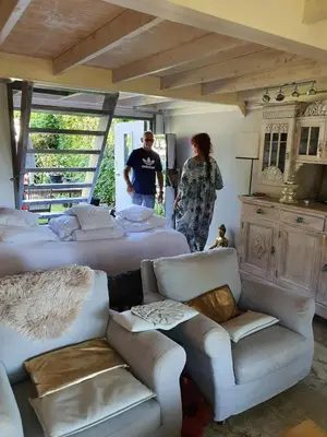 a man and woman standing in a room with beds at Amsterdam Millgreen Den Ilp 198 in Den Ilp