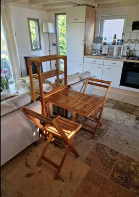 a living room with a wooden table and chairs at Amsterdam Millgreen Den Ilp 198 in Den Ilp