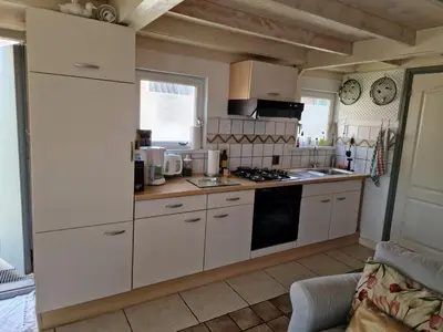 a kitchen with white cabinets and a stove top oven at Amsterdam Millgreen Den Ilp 198 in Den Ilp