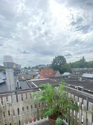 a view of a parking lot from a balcony at Bubbles & Bed in Bilthoven