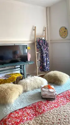 a room with a bed with a rug and a table at Bubbles & Bed in Bilthoven