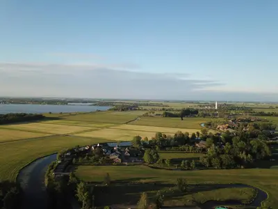 an aerial view of a farm and a river at Trekkershut - De Hollandse Boerderij in Ons Belang