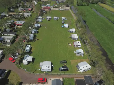 an aerial view of a bunch of camper vans parked in a field at Trekkershut - De Hollandse Boerderij in Ons Belang