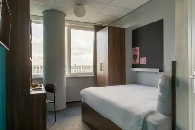 a hotel room with a bed and a window at The Social Hub Amsterdam West Extended Stay in Amsterdam