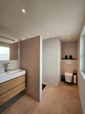 a bathroom with a sink and a toilet at Bed and Beach in Schoorl in Schoorl