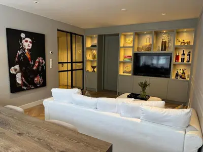 a living room with a white couch and a tv at Luxurious, spacious appartment in Amsterdam