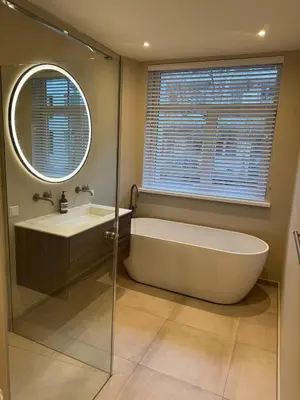 a bathroom with a tub and a sink and a mirror at Luxurious, spacious appartment in Amsterdam