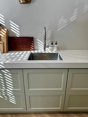 a kitchen with a sink and white cabinets at Luxurious, spacious appartment in Amsterdam