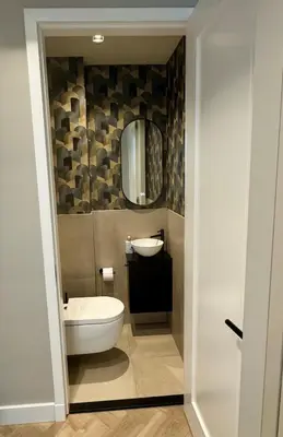 a bathroom with a toilet and a sink and a mirror at Luxurious, spacious appartment in Amsterdam