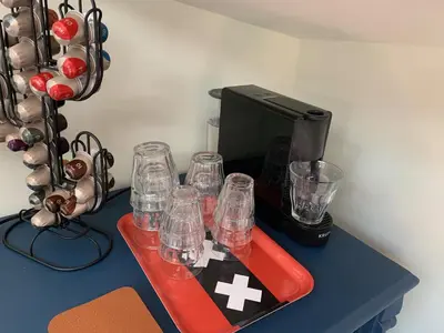 a table with glasses and a coffee maker on it at Appartement op woonboot hartje centrum in Amsterdam
