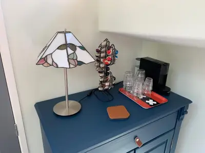 a blue dresser with a lamp on top of it at Appartement op woonboot hartje centrum in Amsterdam